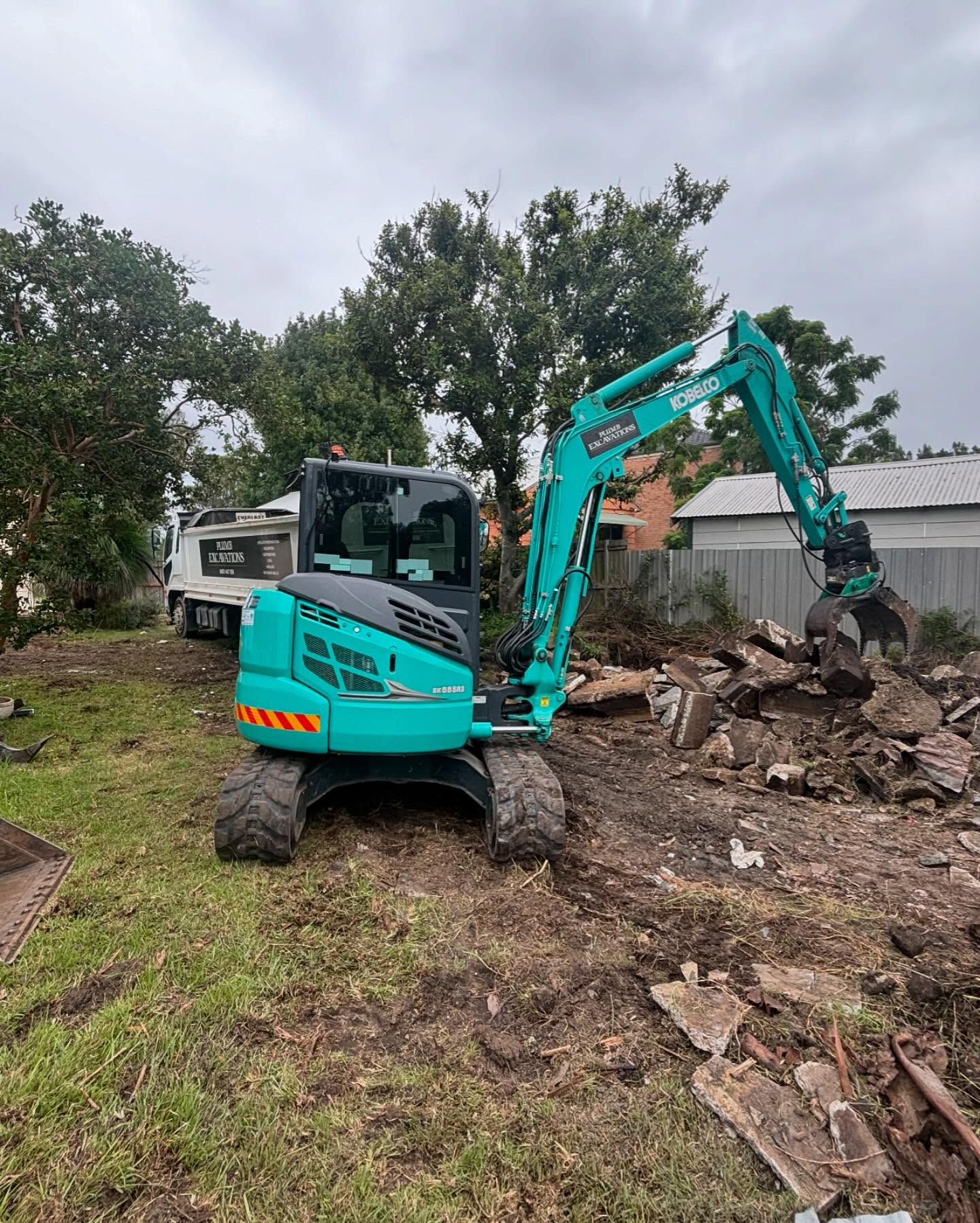 Excavator working a residential site by Plumb Excavations